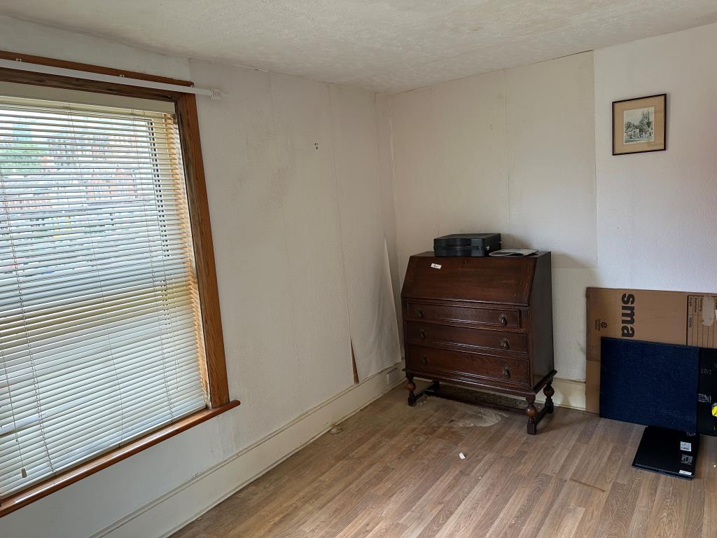Lot: 77 - TWO-BEDROOM TERRACED HOUSE FOR REFURBISHMENT - Bedroom one with window overlooking front garden